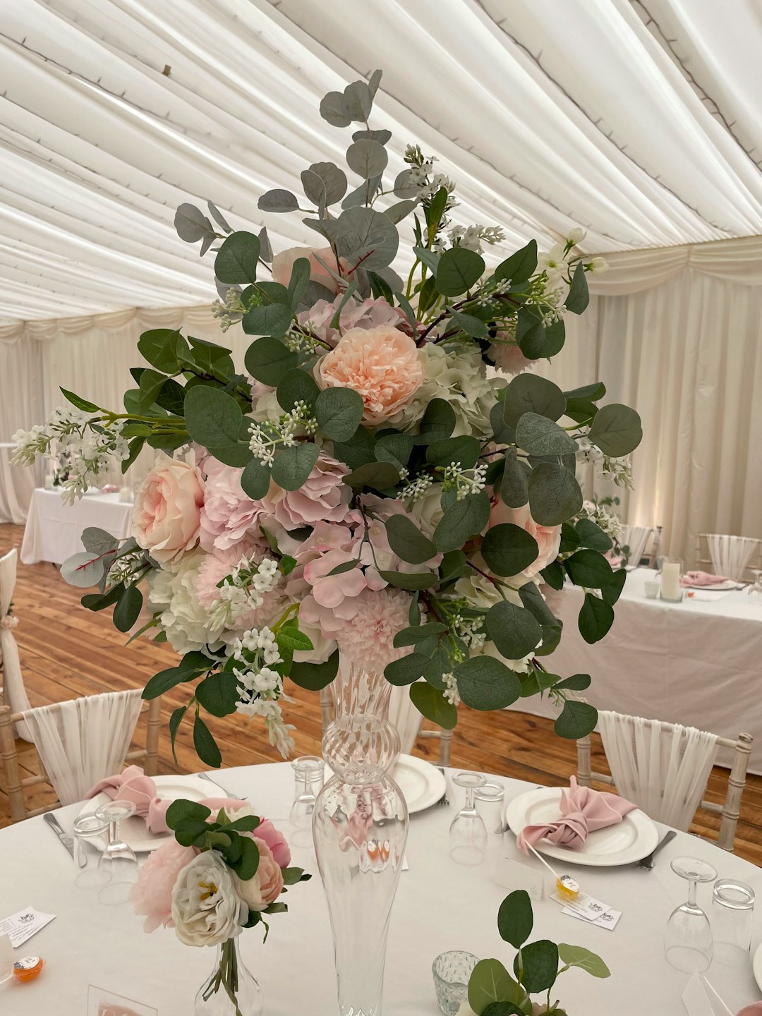 Elegant floral centerpiece displayed on a table at a wedding.